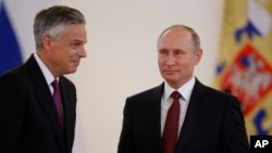 U.S. Ambassador Jon Huntsman, left, walks after presenting credentials to Russian President Vladimir Putin during a ceremony in the Kremlin, in Moscow, Russia, Oct. 3, 2017.