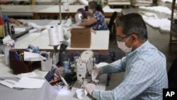 资料图:位在美国凤凰城的床垫工厂Ortho Mattress在疫情期间改生产口罩。(2020年4月6日,美联社)