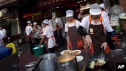 Schoolchildren pose for a picture with Tokyo 2020 Olympic Games' robot-type mascot Miraitowa during a ceremony at Hoyonomori elementary school in Tokyo, Japan.