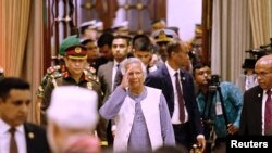 FILE PHOTO: Nobel laureate Muhammad Yunus salutes to the attendees upon arrival at the Bangabhaban to take oath as the head of the interim government