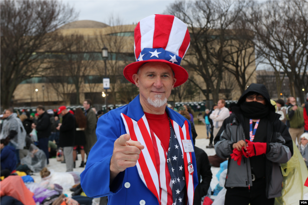 A Trump supporter dressed as "Uncle Sam" in head-to-toe red, white and blue awaits Donald Trump's inauguration as the 45th president of the United States, Jan. 20, 2017. (Photo: B. Allen / VOA)
