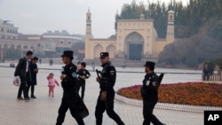 资料照:中国新疆喀什警察在一座清真寺前巡逻。 (2017年11月4日)