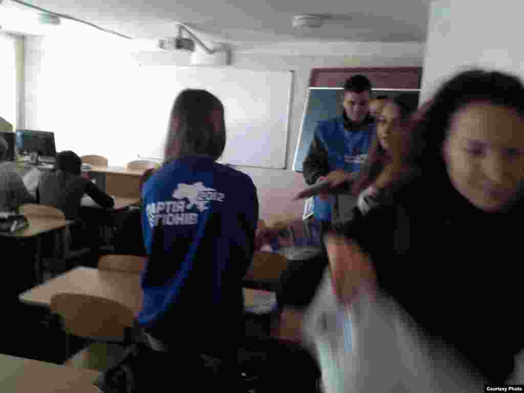 A man carries an injured woman away from the site of a car bomb explosion in a southern suburb of Beirut, Jan. 2, 2014.