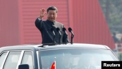 中国国家主席习近平在北京天安门广场举行的阅兵式上乘车检阅。(2019年10月1日)