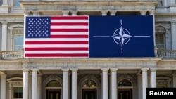 华盛顿艾森豪威尔行政大楼为北约峰会的召开挂上美国和北约的旗帜。(2024年7月8日)
