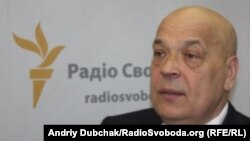A man reacts near bouquets of flowers as people pay tribute near the scene where a truck ran into a crowd at high speed killing scores and injuring more who were celebrating the Bastille Day national holiday, in Nice, France, July 15, 2016.