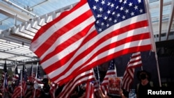 资料照:香港反送中抗议者在香港大学校园举行的集会中手持美国国旗。(2019年9月20日)