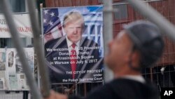 Workers build a podium that President Donald Trump will speak from during a visit to Poland this week in Krasinski Square in Warsaw, Poland, July 3, 2017.