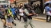 大批香港防暴警察2020年5月27日中午在中环毕打街一带多次施放胡椒球弹,驱散反对中国国歌法立法的示威群众。 (美国之音汤惠芸拍摄)