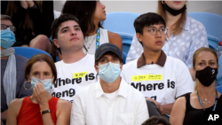 澳大利亚人权活动人士柏乐志(左)和澳籍香港活动人士莫炽韬在2022澳大利亚网球公开赛女子单打决赛的观众席上。