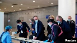 资料照片:世卫组织新冠病毒源头调查组成员抵达上海浦东机场。 (2021年2月10日)