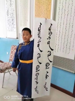 8月20日,内蒙古一名小学生手持“外语是工具,母语是灵魂”的标语,抗议当地教育部门将以汉语替代蒙语的“双语教学”计划。(照片由SMHRIC提供)