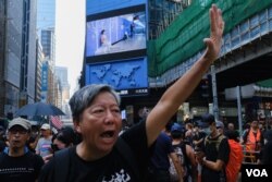 资料照:十一游行的组织者之一李卓人张开手掌(代表五代诉求),振臂高呼五大诉求、缺一不可 (美国之音鸣笛拍摄)