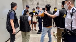 数十名警员包围准备游行的4名社民连成员及采访的记者,逐一搜查游行人士的背包、登记身分证资料,并有警员全程录影,面对一些4人游行,布防非常严密 (美国之音/汤惠芸)