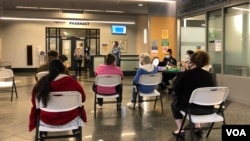 资料照片:在马里兰州巴尔的摩的约翰霍普金斯门诊中心,人们接种了第二剂辉瑞新冠疫苗后坐在观察区内。(2021年5月1日)