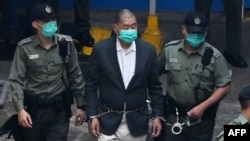 资料照片:香港民主派媒体大亨黎智英被警察带入警车,前往法庭接受涉国安法的指控。(2020年12月12日)