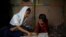 Yasmin, a Rohingya girl who was expelled from Leda High School for being a Rohingya, helps her younger sister to study in Leda camp in Teknaf, Bangladesh, March 5, 2019. REUTERS/Mohammad Ponir Hossain