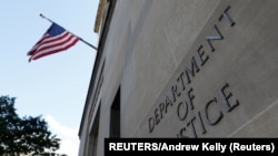 资料照片: 位于华盛顿的美国司法部总部大楼前的标识。