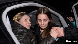 乌克兰反政府领导人季莫申科(左)抵达基辅机场时受到支持者的欢迎。