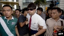 在曼谷一处购物中心举行的示威期间,泰国警察逮捕一名反政变抗议者。(2014年6月22日)