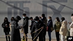 北京市民在一个流动检测站前排起长龙,等待进行新冠病毒核酸检测。