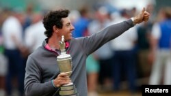FILE - Rory McIlroy of Northern Ireland celebrates as he holds the Claret Jug after winning the British Open Championship at the Royal Liverpool Golf Club in Hoylake, northern England, July 20, 2014.