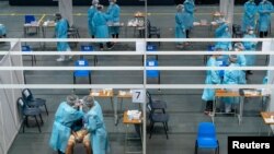 医护人员在香港的一个社区检测中心给市民进行新冠病毒检测。(2020年9月1日)