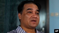 FILE - Outspoken Uighur scholar and advocate Ilham Tohti speaks during an interview at his home in Beijing.