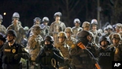 警察和国民警卫队在弗格森警察局前警戒,面对示威群众(2014年11月28日)