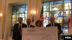 台湾捐赠美国红十字会的50万美元支票,左起为美国国务院台湾协调处处长何乐进、台湾驻美代表高硕泰、美国红十字会会长麦戈文女士、美国在台协会执行理事罗瑞智(2017年9月12日,美国之音钟辰芳拍摄)