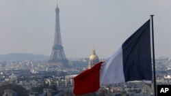 从法国巴黎先贤祠穹顶的柱廊上,可以看到法国首都天际线上方的法国国旗与埃菲尔铁塔(2016年4月1日)。