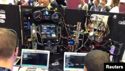 FILE - Attendees of the 2019 DEF CON cybersecurity event are seen at the conference's car hacking village in Las Vegas, Nevada, August 9, 2019.