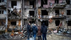 2月25日,人们目睹着乌克兰基辅被火箭摧毁的建筑物.