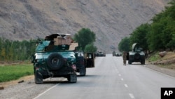 在阿富汗北部巴达赫尚市附近与塔利班交战的前线,阿富汗政府士兵在路上暂停。(2021年7月4日)