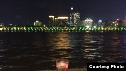 7月15日,作家黎学文在珠江边点燃蜡烛纪念刘晓波。(脸书图片)