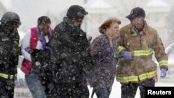 两名女士被转移出科罗拉多州斯普林斯的一座建筑,枪手据怀疑困守在建筑内。(2015年11月27日)