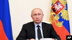 Russian President Vladimir Putin attends a meeting via video conference at the Novo-Ogaryovo residence outside Moscow, Russia, Wednesday, June 10, 2020. Putin held a meeting on IT and telecom industries on Wednesday and urged the government to make…