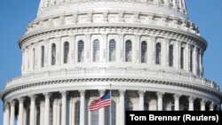 USA, Washington, The American Flag flies at the U.S. Capitol Building