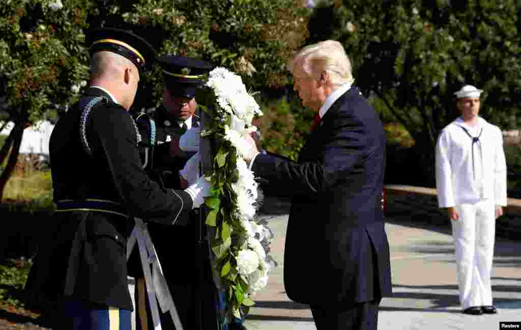 U.S. President Donald Trump lays a wreath during the 9/11 observance at the National 9/11 Pentagon Memorial in Arlington, Virginia, Sept. 11, 2017.