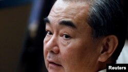 This aerial photo shows farmers drying corn, soybeans and hot pepper as they form an image paying respect to medical workers and soldiers in Huangshan, in China's eastern Anhui province.