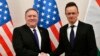 Hungarian Minister of Foreign Affairs and Trade Peter Szijjarto, right, shakes hands with US Secretary of State Mike Pompeo in the ministry in Budapest, Hungary, Feb. 11, 2019.