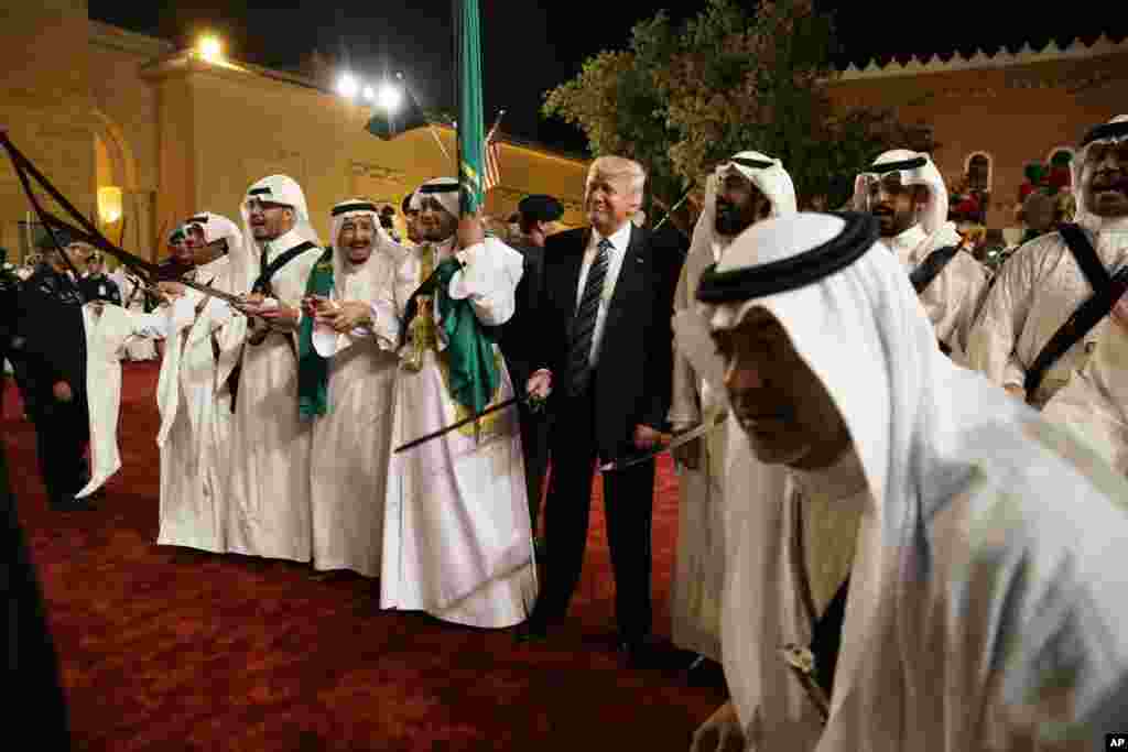 President Donald Trump holds a sword and sways with traditional dancers during a welcome ceremony at Murabba Palace in Riyadh, Saudi Arabia, May 20, 2017.