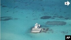 In this photo taken Feb. 28, 2013 by a surveillance plane, and released Thursday, May 15, 2014, by the Philippine Department of Foreign Affairs, Chinese-made structures stands on the Johnson Reef.