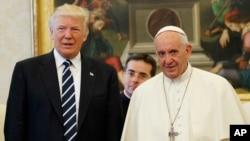 U.S. President Donald Trump stands with Pope Francis during a meeting, May 24, 2017, at the Vatican.