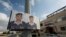 Two posters with pictures of Jordanian pilot, Lt. Muath al-Kaseasbeh, who is held by Islamic State group militants, and Arabic that reads "we are all Muath," hang on a street pole, in front of the captured pilot's tribal gathering place, in Amman, Jordan,