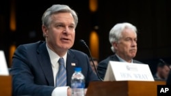 美国联邦调查局长克里斯托弗·雷(图左)2024年3月11日出席参议院情报委员会针对全球威胁召开的听证会。(美联社)