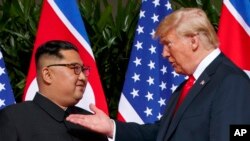 FILE - US President Donald Trump meets with North Korean leader Kim Jong Un on Sentosa Island in Singapore, on June 12, 2018.