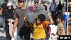 在以色列下达撤离令后,流离失所的巴勒斯坦人逃离汗尤尼斯的东部区域。(2024年8月8日)