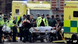 ဒဏ်ရာရသူတွေကို အရေးပေါ်လူနာတင်ကားနှင့် သယ်ဆောင်နေစဉ်။