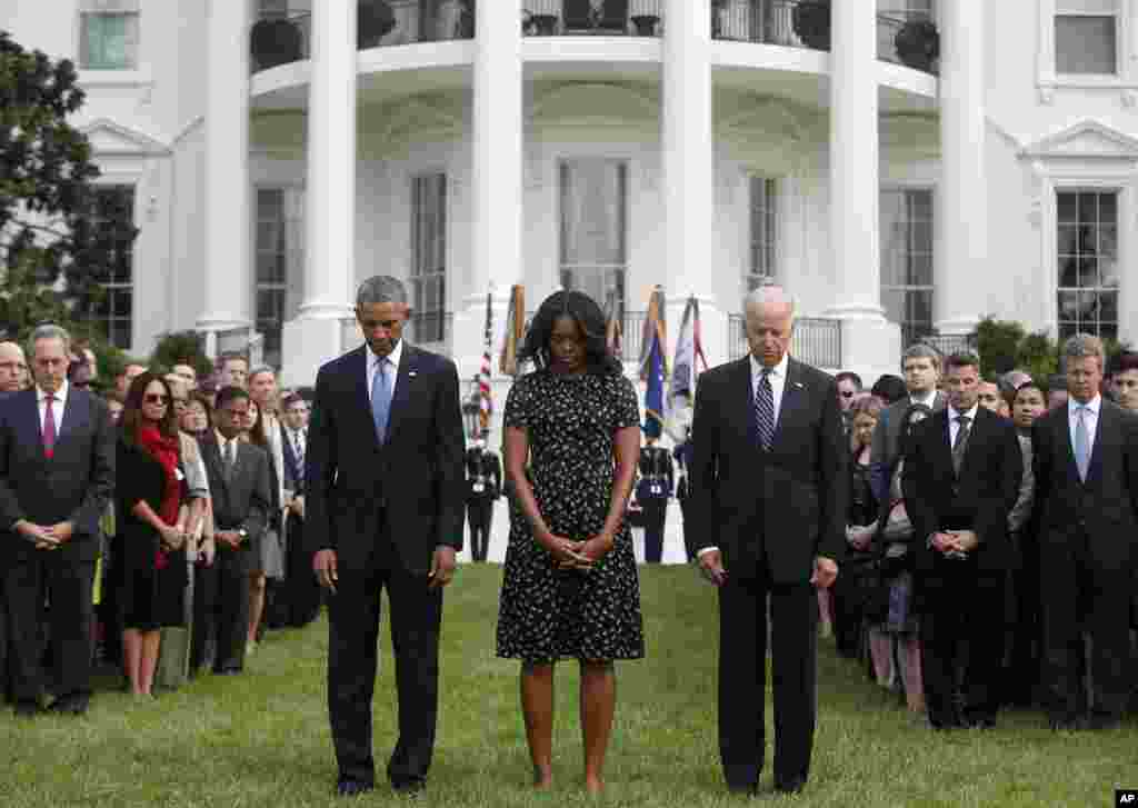 President Barack Obama, First Lady Michelle Obama, Vice President Joe Biden, and others observe a moment of silence to mark the 13th anniversary of the 9/11 attacks, on the South Lawn of the White House, in Washington, Sept. 11, 2014.